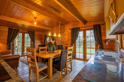 Large three bedroom log cabin with private hot tub and decking over looking the beautiful river Brue