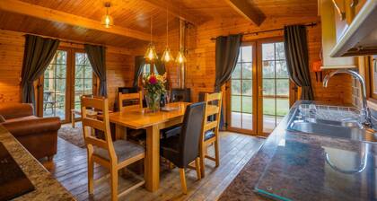 Large three bedroom log cabin with private hot tub and decking over looking the beautiful river Brue
