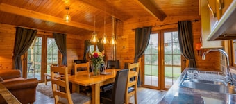 Large three bedroom log cabin with private hot tub and decking over looking the beautiful river Brue