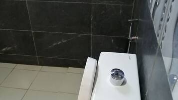 A bathroom with a toilet, a bidet, and a sink.
