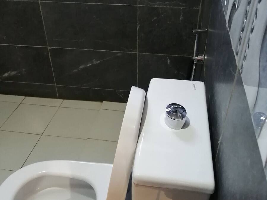 A bathroom with a toilet, a bidet, and a sink.