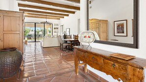 A spacious room with a large wooden cabinet, a mirror, and a tiled floor. - Los Estados #66 - 3 BD /3.5 BA, 2586sf (La Quinta)