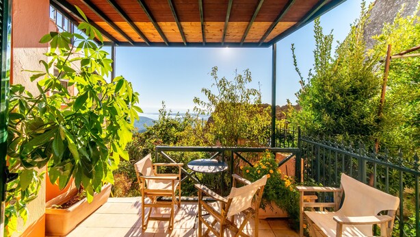 A covered outdoor seating area with a view of the landscape. - Holiday Home "Balis Panorama" with Sea View, Balcony, Garden & Wi-Fi (Corfu)