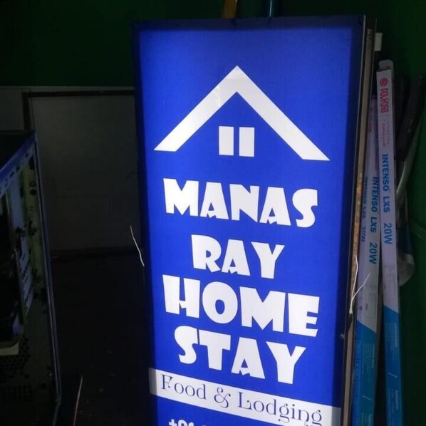 A sign for "Manas Ray Home Stay" offering food and lodging.