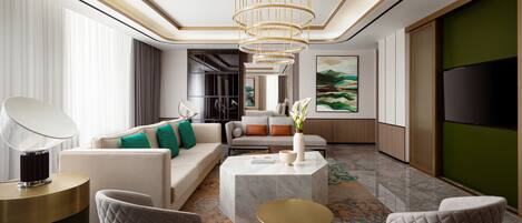 Un salon moderne avec un canapé, des fauteuils, une table basse et un lustre.