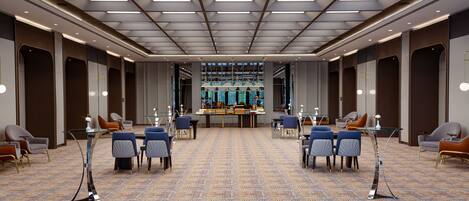 A spacious conference room with a patterned carpet, modern chairs, and a central buffet table.