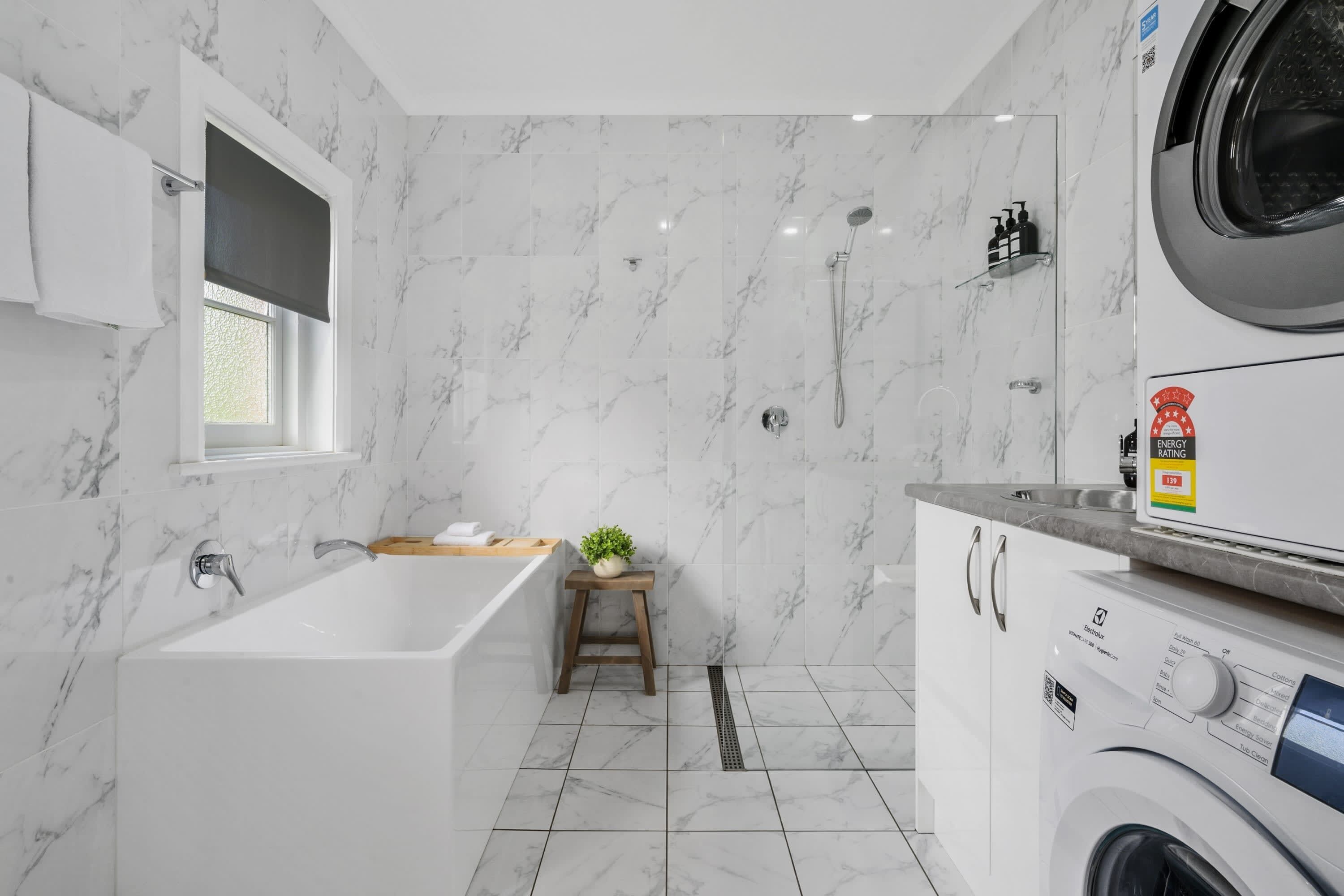 Bathtub, hair dryer, towels, shampoo