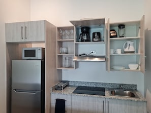 Fridge, microwave, stovetop, coffee/tea maker