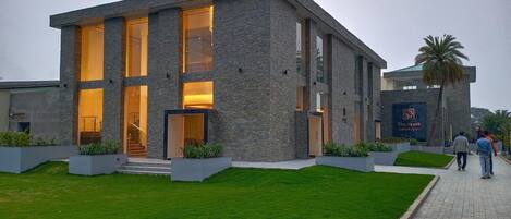 A modern building with large windows and a stone facade.