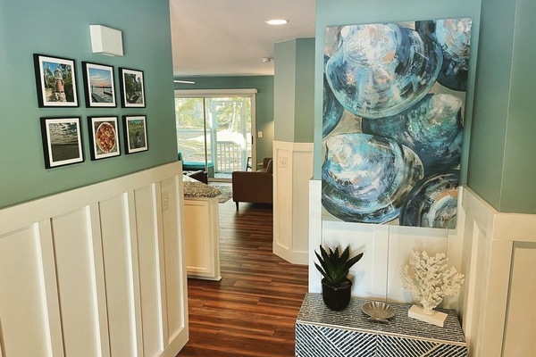 Inviting entryway with local photography & coastal art to greet you.