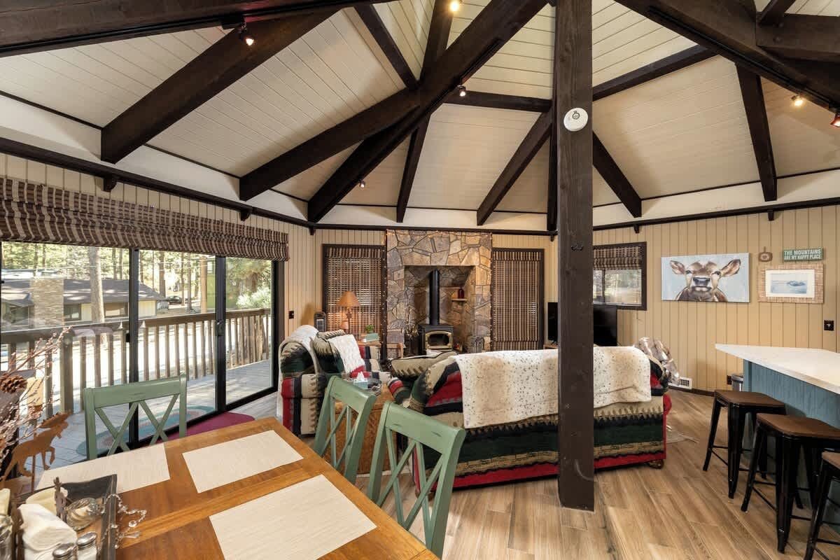 A cozy interior with a dining area, a fireplace, and a bar.