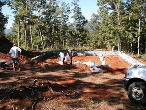 Construction underway in a serene forest setting.