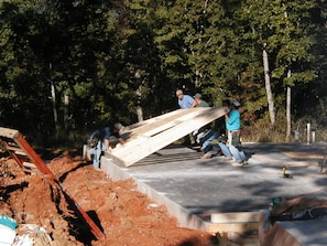 Construction underway on a new outdoor space amidst lush surroundings.