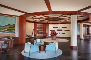 A spacious lobby with a central seating area, a large painting on the wall, and a reception desk. - Taj Wayanad Resort & Spa, Kerala (Vythiri)