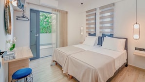 Une chambre moderne avec deux lits, un bureau et une chaise.