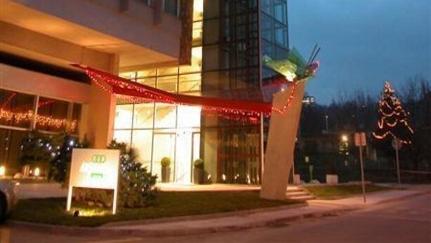 A modern hotel with a glass facade, a flat roof, and a sign indicating a restaurant. - Olympik Artemis Hotel (Prague)