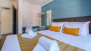 A hotel room with a bed, a desk, a chair, and a mirror. - The Douglas  2 Bed Apartment in Uddingston (Uddingston)