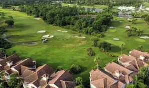 A golf course with sand bunkers and a clubhouse. - Lovely PGA 1st Floor Studio (Port St. Lucie)