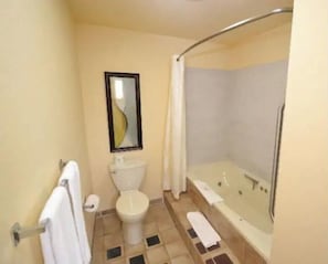 Combined shower/bathtub, jetted bath, towels, toilet paper
