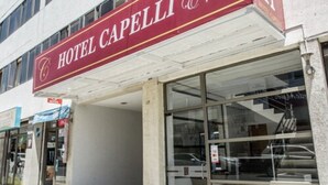 A hotel entrance with a maroon sign reading "HOTEL CAPELLI." - Hotel Capelli Express (Talca)