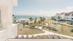 A resort with a pool, palm trees, and a view of the ocean. - Ocean View From Your Studio at Punta Palmera GC5 (Punta Cana)