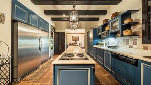 Enjoy cooking in this well-equipped kitchen with a central island, stovetop, and seating area.