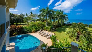 A pool area with lounge chairs, a view of the ocean, and tropical vegetation. - Beachfront Potrero Nice 7-br Villa Chef Included - Casa Royal (Tempate)