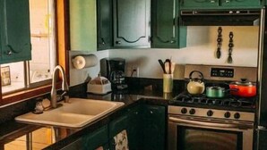 A kitchen with green cabinets, a sink, a stove, and a dishwasher. - Cardiff Hope House with Ocean View (Encinitas)