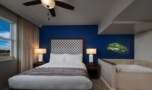 Relax in this stylish room with a large bed, two bedside tables, and a spacious bathtub.