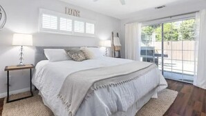 A bedroom with a bed, a ceiling fan, a window with blinds, and a view of the outdoors. - Pet Friendly Paso Robles Wine Retreat (Templeton)