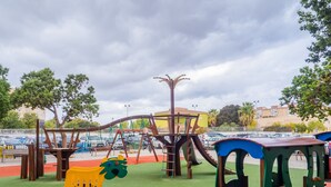 A playground with swings, slides, and climbing structures. - Cubo's Urban Studio Turisbelen / city / free wifi (Málaga)