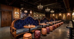 A bar with wooden booths, leather stools, and a bar counter. - Jakes Place: Pool, Hot Tub, Billiards, Gazebo, BBQ, Fire Pit (Gilbert)
