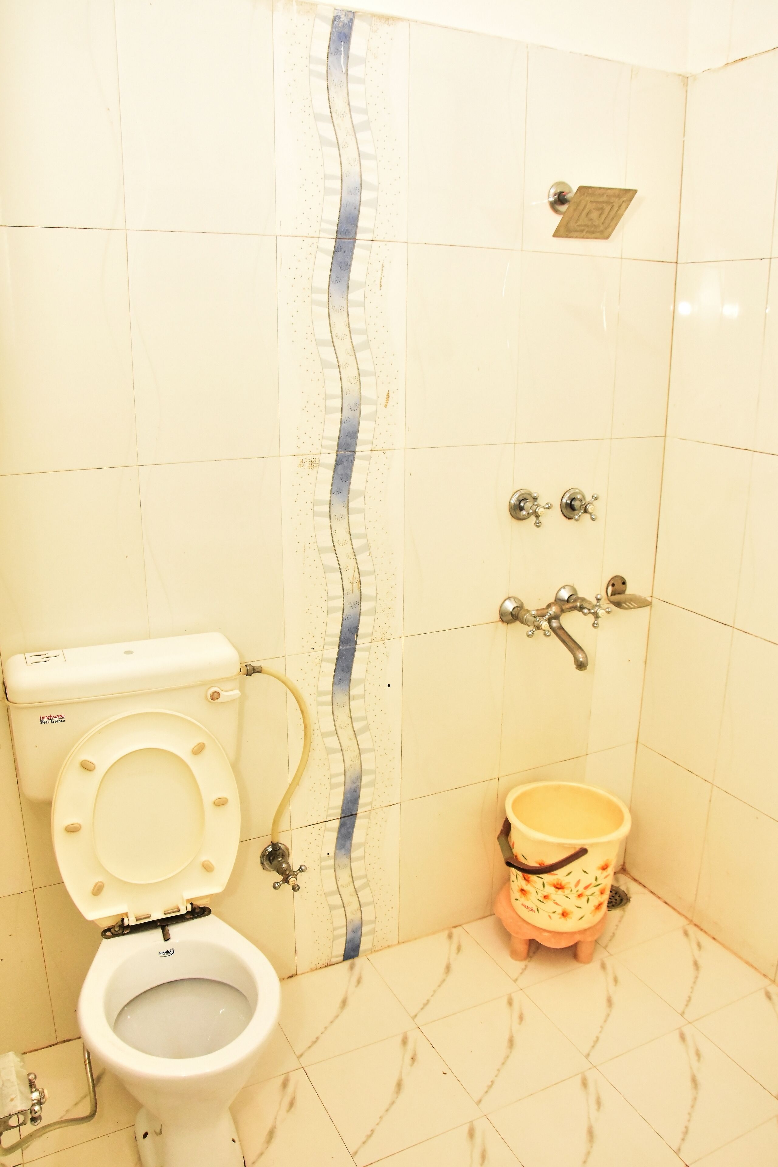 A bathroom with a toilet, a bidet, and a shower.