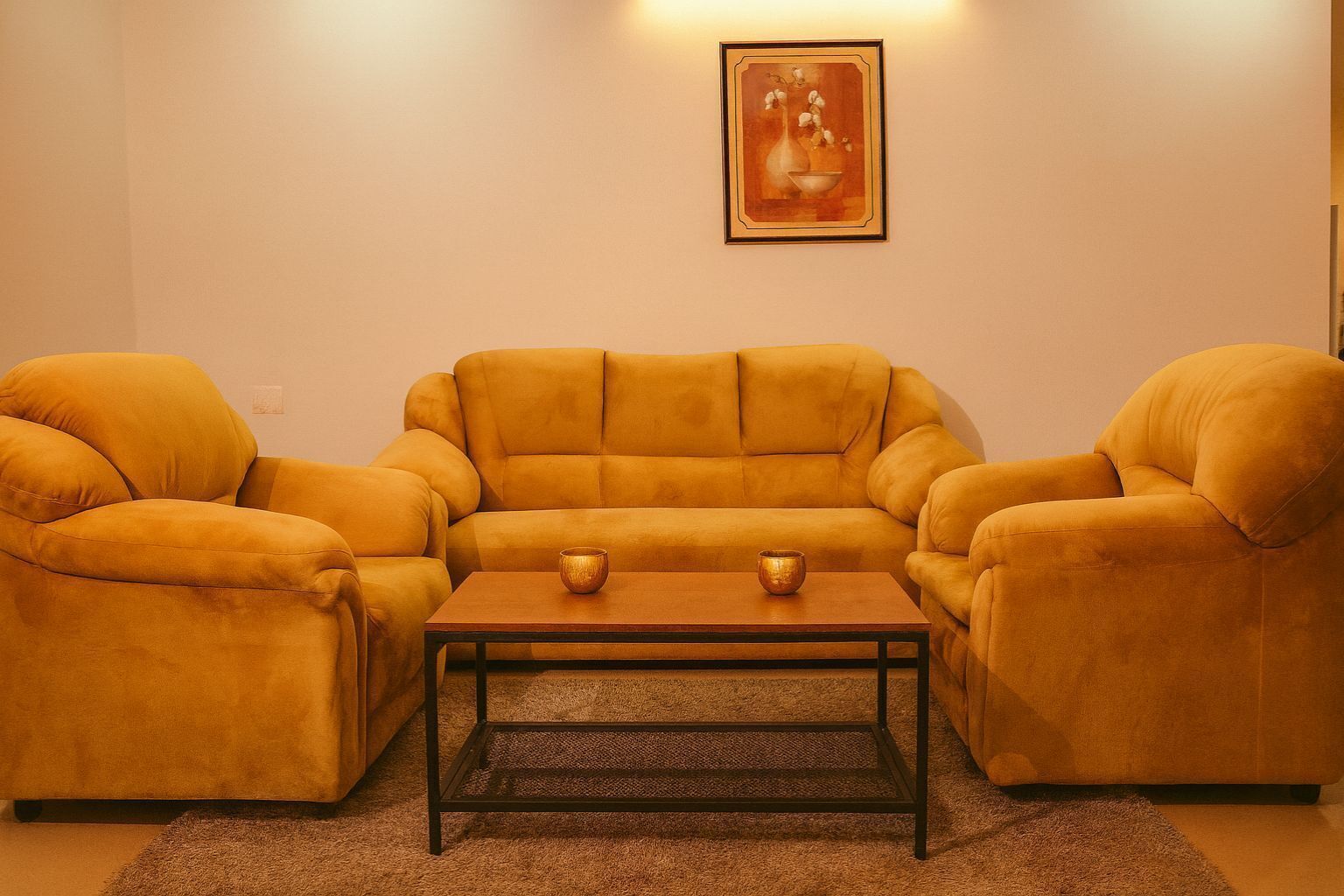 A living room with a sofa set and a coffee table.
