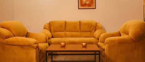 A living room with a sofa set and a coffee table.