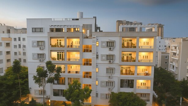 A modern multi-story residential building with balconies, large windows, and a flat roof. - White Fern Stays (Hyderabad)