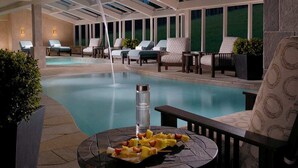 A poolside area with lounge chairs, a table with fruit, and a water feature. - Ski-in/Out 10 Yards to  Lift Arcade Bowling Pool/Hot Tub Pool Table   (Breckenridge)