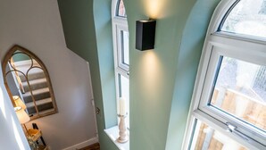A staircase with carpeted steps leading to a landing. - Pilgrim Cottage - Luxury Cottages (Chester)