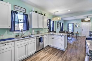Enjoy cooking in this well-equipped kitchen with a central island, dishwasher, and ample counter space.