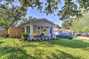 Welcome to this charming home with a cozy front porch, garden, and inviting entrance.