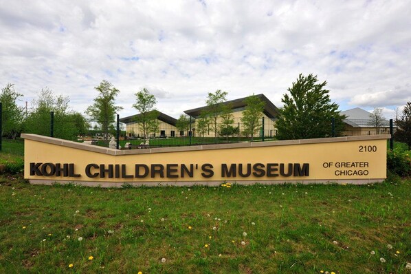 The exterior of the Kohl Children's Museum of Greater Chicago, featuring a prominent entrance sign and a building with a modern design.