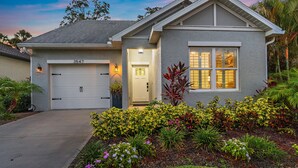 A residential house with a garage, a well-maintained garden, and a driveway.