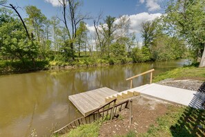 Relax by the serene river, surrounded by lush greenery and a tranquil atmosphere.