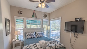 A bedroom with a bed, a ceiling fan, a TV, and windows with blinds. - Great Location minutes from Golfing & the Beach! (Myrtle Beach)