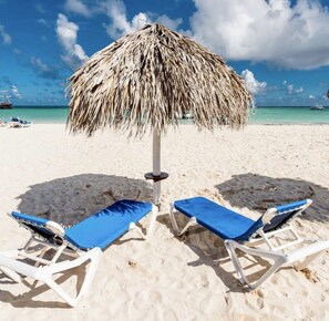 On the beach, sun loungers, beach towels