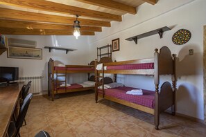 A dormitory room with bunk beds, a television, a dartboard, and a framed picture on the wall. - Fantastic Villa for 12 people with pool and barbecue. (Caimari)