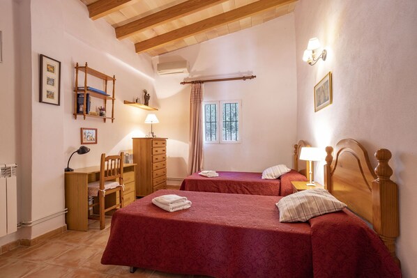 A bedroom with two beds, wooden headboards, a desk, a chair, a dresser, and a window with curtains. - Fantastic Villa for 12 people with pool and barbecue. (Caimari)
