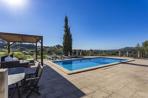 A rooftop pool with lounge chairs, a pergola, and a view of the countryside. - Fantastic Villa for 12 people with pool and barbecue. (Caimari)