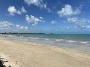 On the beach, white sand, sun-loungers