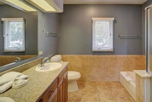 Enjoy a refreshing bathroom experience with a double vanity, granite countertop, and bidet attachment.